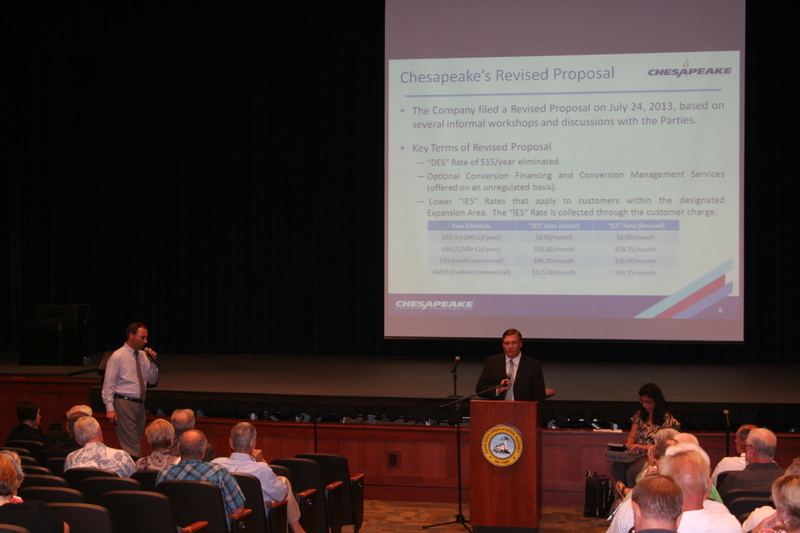 Chesapeake Utilities Corp. Vice President Jeffrey Tietbohl, left, explains the company's proposed natural gas rate structure at a Sept. 12 Delaware Public Utility Commission public hearing at Cape Henlopen High School. PUC hearing examiner Mark Lawrence, right, will recommend actions the panel might take. BY HENRY J. EVANS JR.